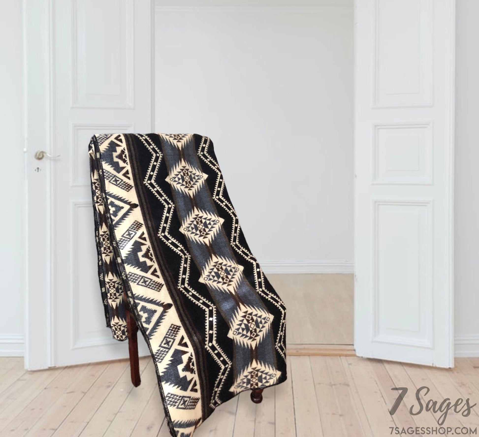 Alpaca Wool Blanket draped over a chair in a white home with wooden floors