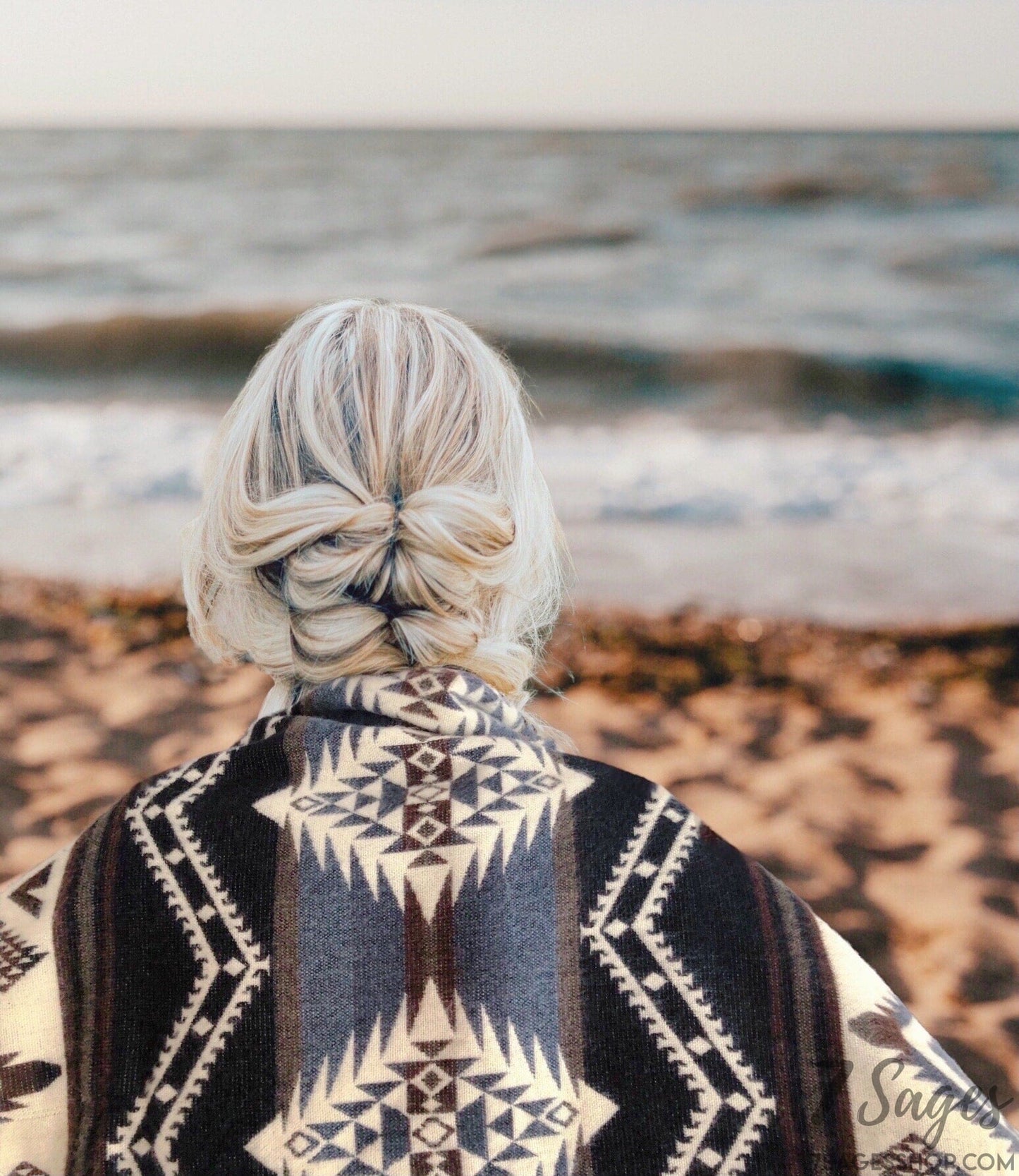 Luxury Alpaca Wool Blanket draped over shoulders of woman at beach with blonde hair during sunset