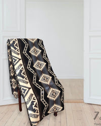 Alpaca Wool Blanket draped over a chair in a white home with wooden floors